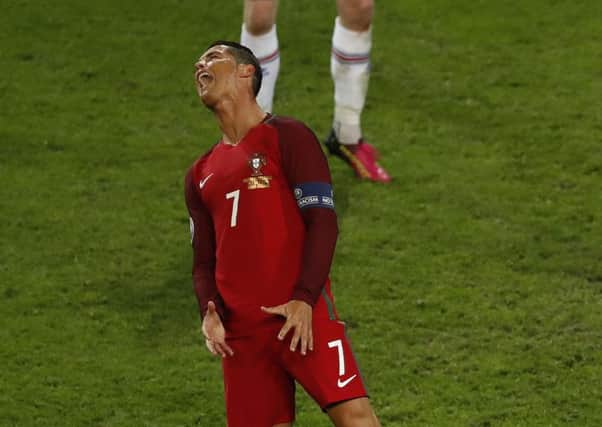 Portugal's Cristiano Ronaldo, left, reacts after a save by Iceland goalkeeper Hannes Halldorsson during the Euro 2016 Group F match between Portugal and Iceland. (AP Photo/Michael Sohn)