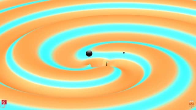 Two black holes are illustrated moments before they collide and merge with each other, releasing energy in the form of gravitational waves - ripples in spacetime.