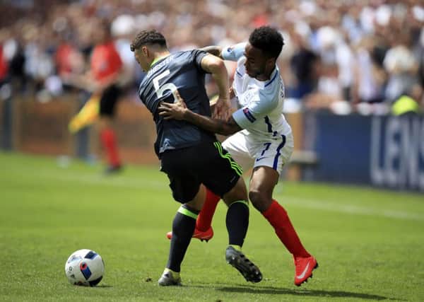 England's Raheem Sterling and Wales' James Chester during the Group B match at the Stade Felix Bollaert-Delelis. Picture: Mike Egerton/PA.