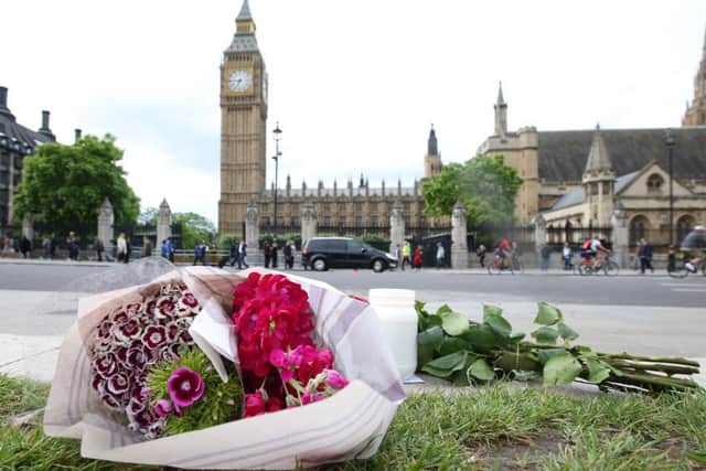Flowers left at Parliament Square opposite the Palace of Westminster, central London, following the death of Labour MP Jo Cox, who died after being shot and stabbed in the street outside her constituency advice surgery in Birstall, West Yorkshire. Picture: Philip Toscano/PA Wire