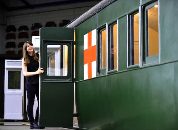 Jane Sparkes from the National Railway Museum in York in front of a  1907 London and South Western railway carraige  which will be the centrepiece of a new exhibition