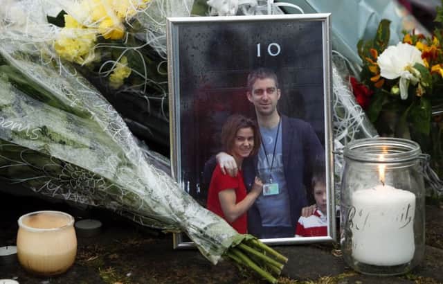 A photo is left amongst floral tributes in Birstall, after Jo Cox was shot and stabbed to death in the street outside her constituency advice surgery.