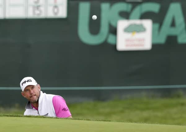 Lee Westwood plays out of the bunker on the seventh hole during the first round of the US Open (Picture: Gene J Puskar/AP).