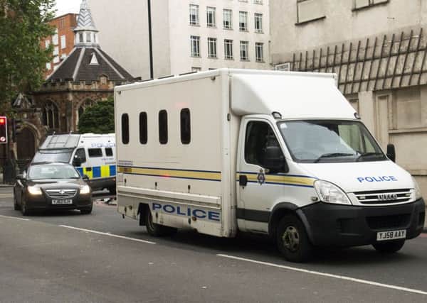 Two police cars and police vans arrive at Westminster Magistrates Court, London, where Thomas Mair was due to appear charged with the murder of Labour MP Jo Cox. PIC: PA