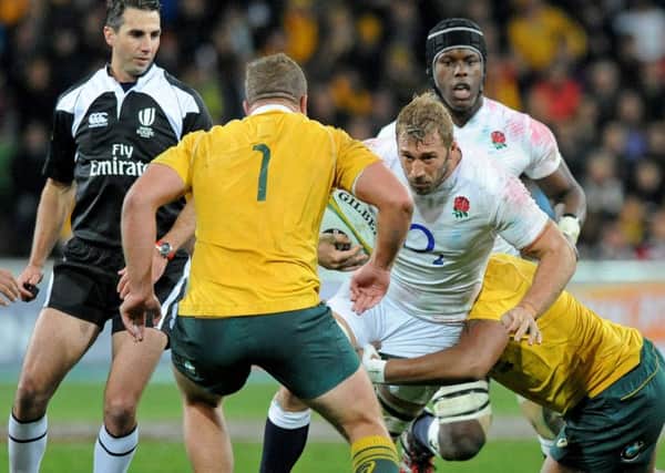 Chris Robshaw, center, is tackled by James Slipper.