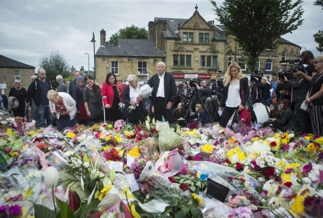 Kim Leadbeater (right), the sister of Labour MP Jo Cox, views floral tributes with her parents Jean and Gordon Leadbeater (centre) in Birstall, West Yorkshire