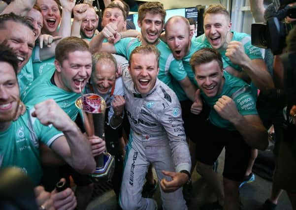Mercedes driver Nico Rosberg of Germany,  celebrates with Mercedes mechanics.