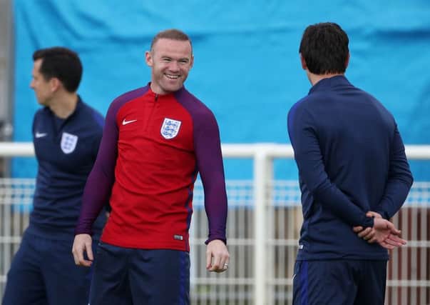 England captain Wayne Rooney shares a joke with England coach and former Manchester United team-mate Gary Neville during a training session at the Stade du Bourgognes, Chantilly (Picture: John Walton/PA).