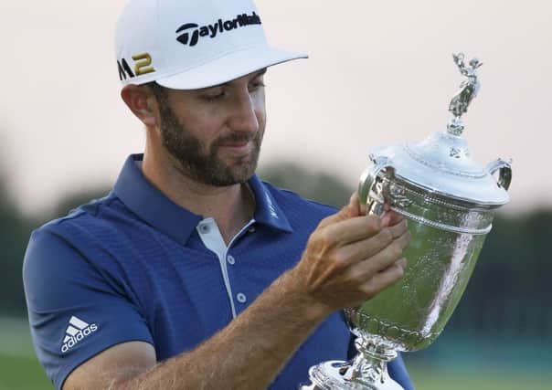 Dustin Johnson holds the trophy after winning the US Open
