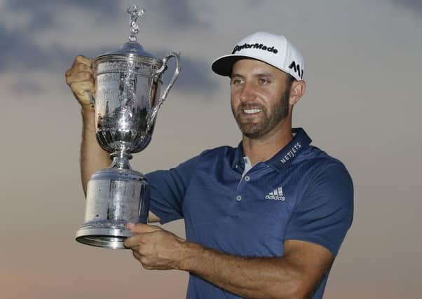 Dustin Johnson holds the trophy after winning the U.S. Open golf championship at Oakmont Country Club. (AP Photo/John Minchillo)
