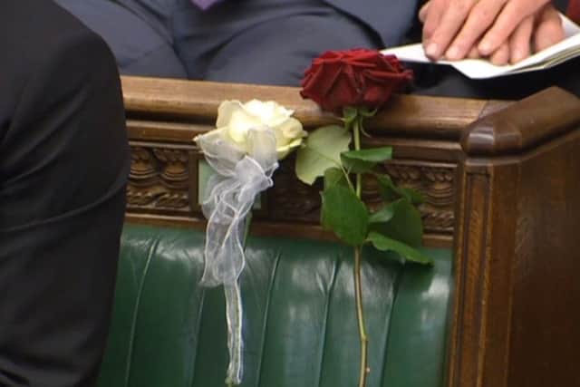 A white and red rose lie on Jo Cox's empty seat in the House of Commons. PIC: PA