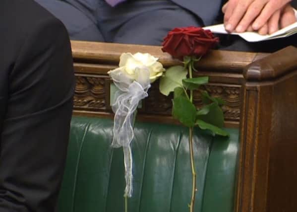 A white and red rose lie on Jo Cox's empty seat in the House of Commons, London, as MPs gather to pay tribute to her. PA Wire