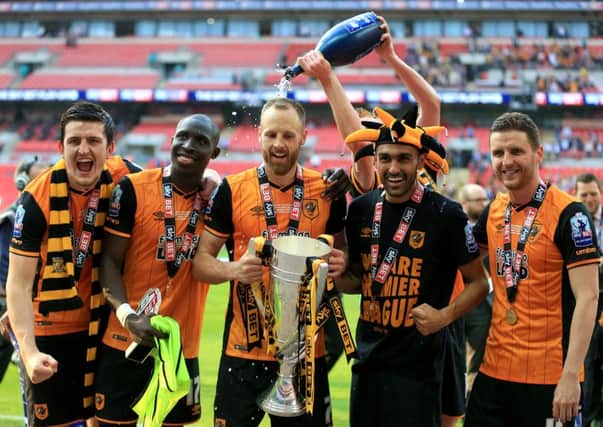 Hull City's player celebrate their Wembley success against Sheffield Wednesday - earning promotion back to the Premier League.