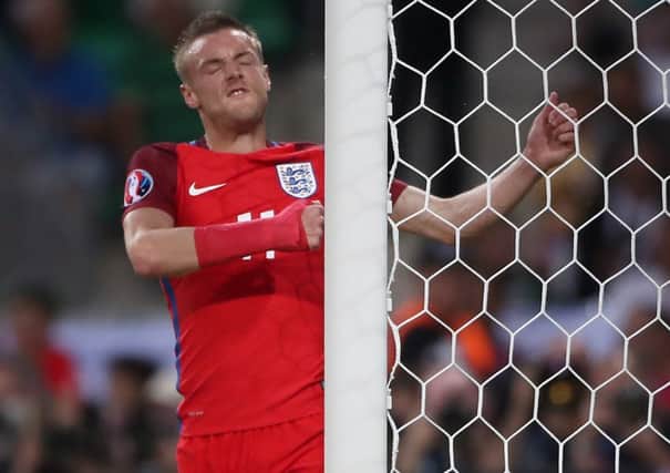 England's Jamie Vardy punches the post in frustration after missing a chance against Slovakia.