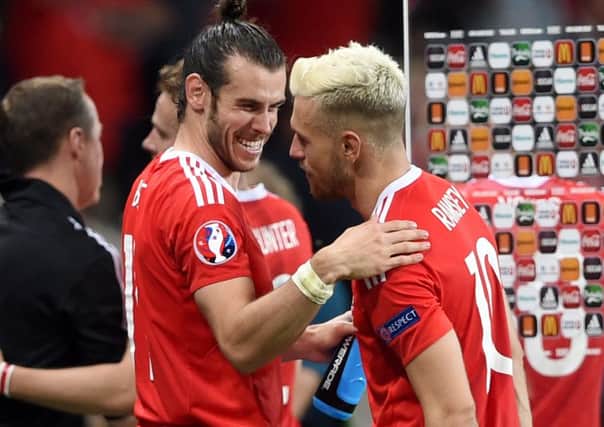 Wales' Gareth Bale (left) and Aaron Ramsey (right) celebrate victory over Russia.