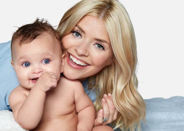 Holly Willoughby with a baby, taken from Truly Happy Baby: It Worked for Me by Holly Willoughby, published by Harper Collins