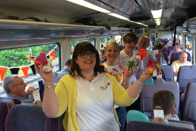 The Thirsk Yarn Bombers onboard the train with Ian Ashton, managing director of The World of James Herriot.