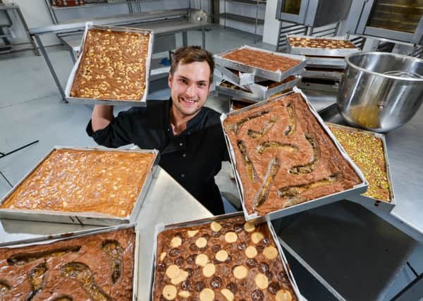 BUSINESS MOVE: George Welton at Brown and Blonds new bakery with a selection of his brownies.
