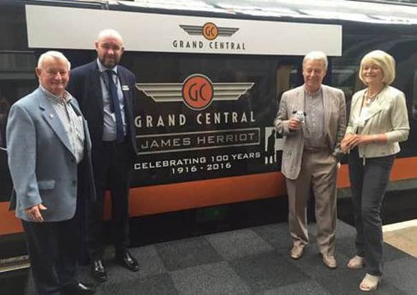 The James Herriot is re-dedicated at a ceremony at King's Cross. Pictured are:
Ian Ashton  Managing Director at World of James Herriot
, Sean English  Chief Operating Officer at Grand Central Rail
, and Wight's children Jim Wight  and Rosie Page
