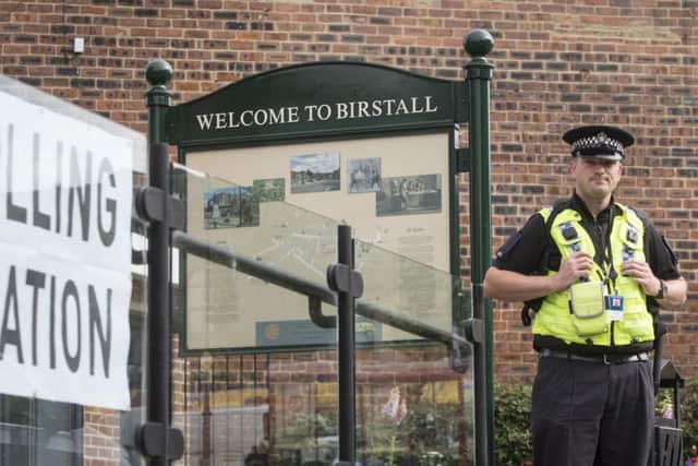 A police officer stands outside a polling station being used in the EU referendum at Birstall library, West Yorkshire, near where Labour MP Jo Cox was attacked and killed outside her constituency surgery.