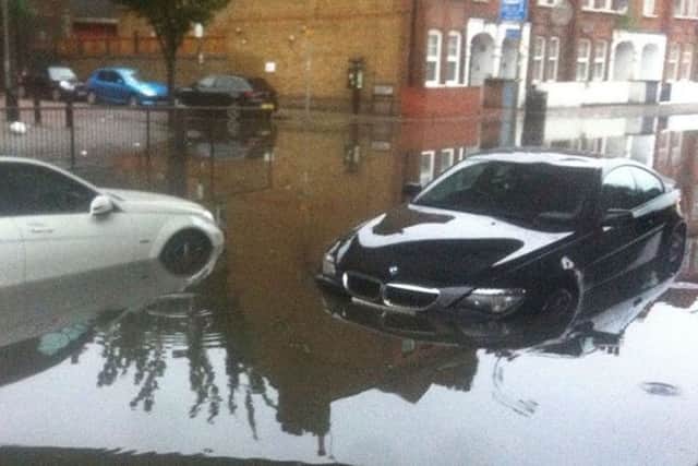 Twitter picture by @Thapelo_VK of heavy overnight rain which left two cars stranded on Queenstown Road, Battersea, London