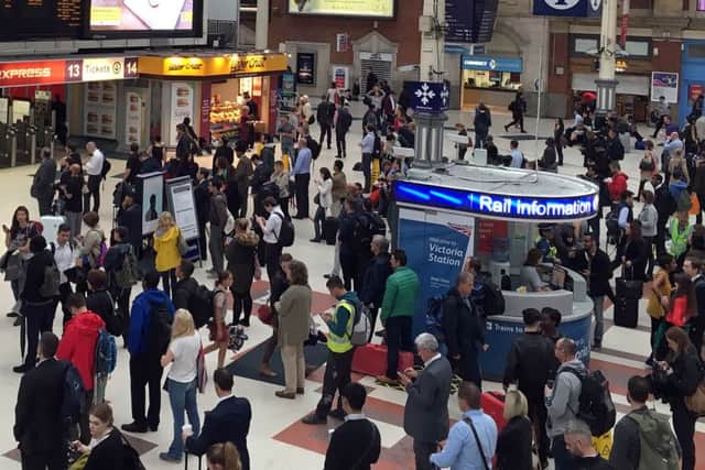 Commuters at Victoria Station, London, as torrential downpours and flooding swamped parts of London