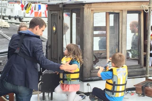Brendan Cox helps his children off a barge boat and onto Westminster Pier. Behind the barge a smaller boat covered in roses called the Yorkshire Rose was towed.