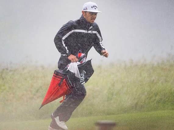 A player runs for cover amid torrential rain at the Brabazon Trophy (Picture: Leaderboard Photography).
