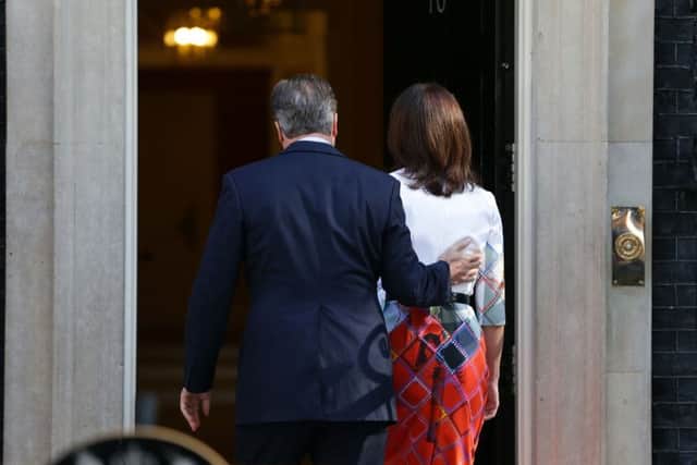 It's goodbye from him: David Cameron walks into 10 Downing Street with wife Samantha after he announced his resignation
