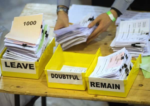 Votes are sorted into Remain, Leave and Doubtful trays as ballots are counted during the EU Referendum. Credit: PA.