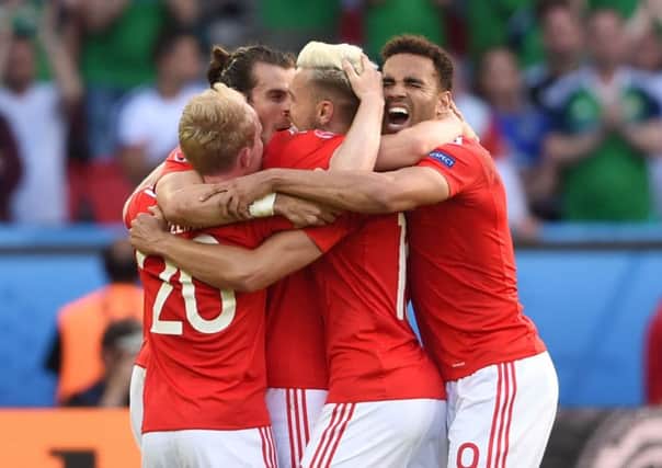 (left to right) Wales' Jonny Williams, Gareth Bale, Aaron Ramsey and Hal Robson-Kanu celebrate on the pitch after the round of 16 match at the Parc de Princes, Paris.