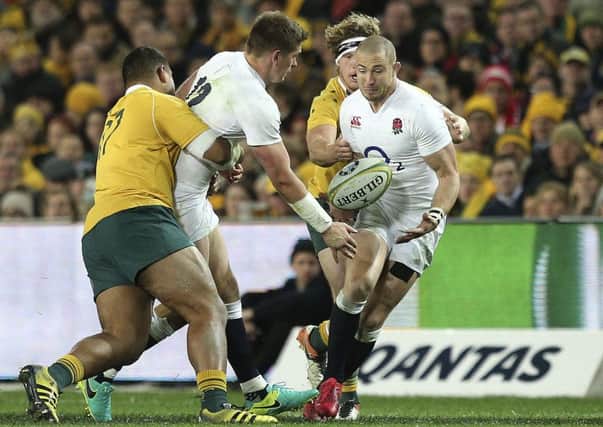 England's Owen Farrell, second left, passes the ball to Mike Brown, right, as Australia's Tevita Kuridrani, left, tackles him. (AP Photo/Rob Griffith)