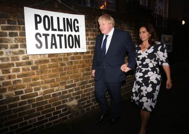 Boris Johnson and his wife Marina arrive to cast their votes at Hanover Primary School in north London.