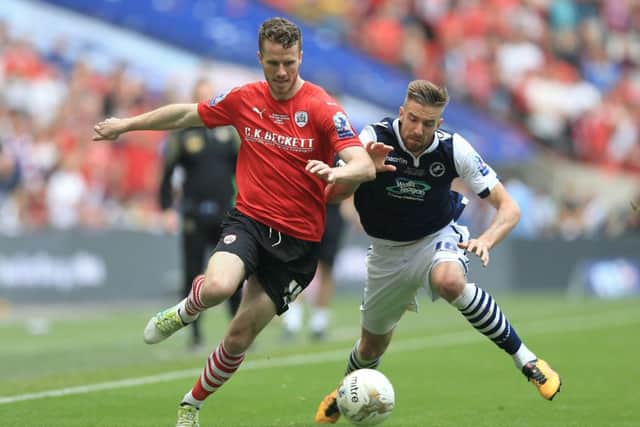 Barnsley's Marley Watkins (left) and Millwall's Mark Beevers battle for the ball during the League One Play-Off Final at Wembley. Picture: Nigel French/PA.