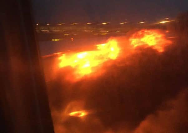 This image provided by Lee Bee Yee shows an engine on fire on a Singapore Airlines flight on Monday, June 27, 2016. A Singapore Airlines statement said the Boeing 777-300ER was on its way to Milan when it turned back "following an engine oil warning message." It says the aircraft's right engine caught fire after Flight SQ368 touched down more than four hours after takeoff. (Lee Bee Yee via AP)
