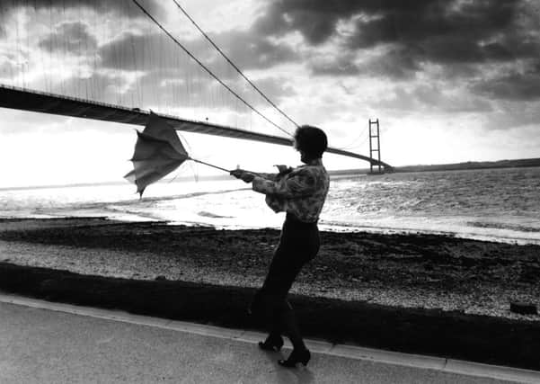 Hull, 17th October 1991.

Ms Tracey Jackson fights to keep control of her umberella underneath the storm lashed Humber Bridge, which was closed to high-sided vehicles because of the winds yesterday.