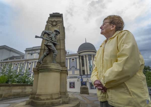 Margaret Spencer,  a member of the Royal Marines Association, looking at the Bradford War Memorial. Picture James Hardisty