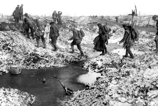 British soldiers negotiating a shell-cratered, Winter landscape along the River Somme in late 1916 after the close of the Allied offensive