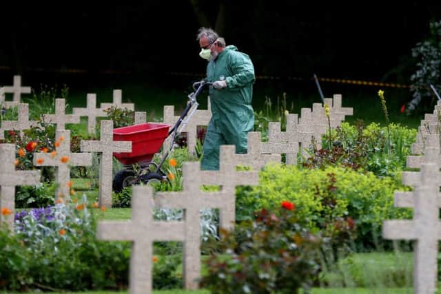 A gardener prepares the headstones around the Thiepval Memorial in France which holds the names of more than 72,000 officers and men who died in the Somme