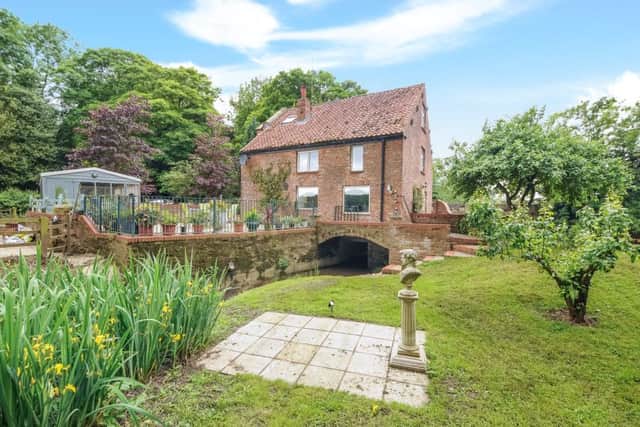 The property has a large garden with mill pond