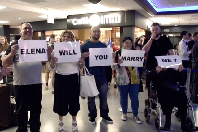 Kyri Tsikkini, 29, proposes to sweetheart Elena Raouna, 25, with the help of a flashmob after they returned from a romantic weekend in Paris. Picture: Ross Parry Agency