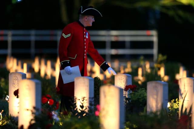 A Chelsea Pensioner stands amongst the war graves during a military-led vigil to commemorate the 100th anniversary of the beginning of the Battle of the Somme at the Thiepval memorial to the Missing.
