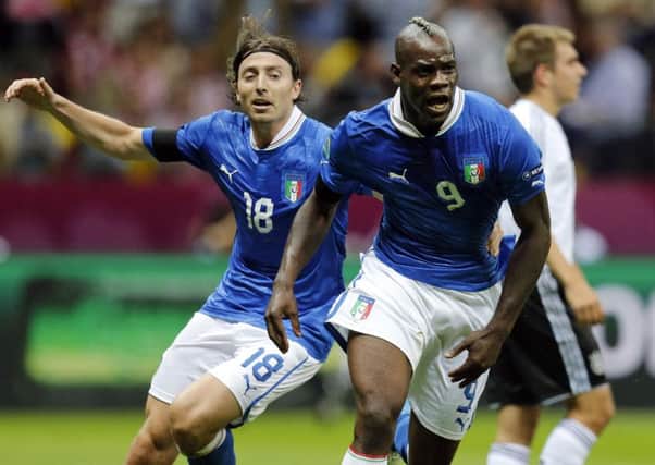 Italy's Mario Balotelli, right, and Riccardo Montolivo celebrate the first goal during the Euro 2012 semi-final match against Germany in Warsaw, Poland. (AP Photo/Matthias Schrader)