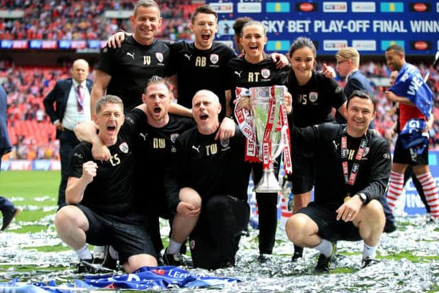 Barnsley caretaker manager Paul Heckingbottom (right) celebrates with the trophy alongside goalkeeper coach John Vaughan (back left), assistant head coach Tommy Wright (front second right)