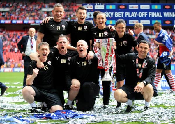 Barnsley caretaker manager Paul Heckingbottom (right) celebrates with the trophy alongside goalkeeper coach John Vaughan (back left), assistant head coach Tommy Wright (front second right)