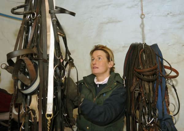 Jo Foster sorting out the tack at her stables at Menston near Leeds .