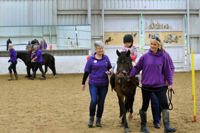 Volunteers with young riders at Follifoot Park Disabled Riders Group, which is one of three charities nominated for the Group award at this year's Yorkshire Children of Courage Awards.
