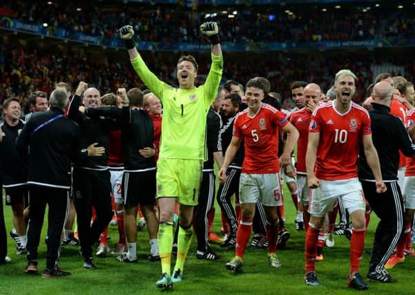 Wales goalkeeper Wayne Hennessey (centre) celebrates with teammates and coaching staff after the UEFA Euro 2016 quarter final match at the Stade Pierre Mauroy in Lille.
