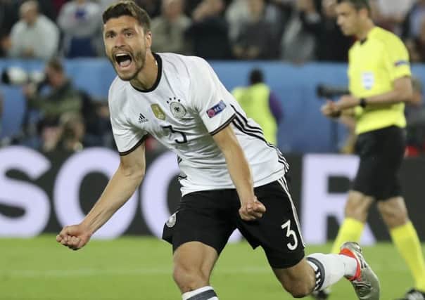Germany's Jonas Hector celebrates after scoring the winning penalty during the Euro 2016 quarterfinal soccer match between Germany and Italy, at the Nouveau Stade in Bordeaux. (AP Photo/Antonio Calanni)
