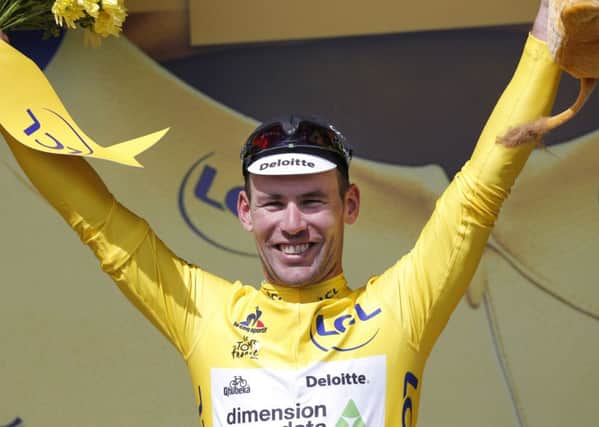 After all he has accomplished in the Tour de France, Mark Cavendish was finally able to slip his arms into the yellow jersey after his victory at Utah Beach on Saturday. (AP Photo/Christophe Ena)